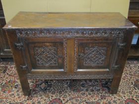 18th century oak country made hall cupboard, enclosed by a pair of panelled floors with carved
