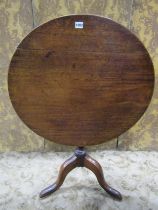 A Georgian mahogany snap-top occasional table with circular top raised on a vase shaped pillar and