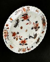 An 18th century Chinese Kangxi Imari plate decorated with flowers and insects, the dish of oval form