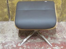 A contemporary chrome and leather Eames style footstool