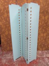 A contemporary art deco style pale blue painted hinged room dividing screen with stepped rectangular