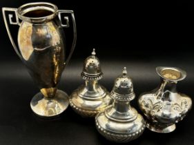A group of silver pieces to include a pair of salt and pepper shakers, a silver trophy, a posy vase,