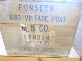 A wooden case of twelve bottles of Fonseca 1980 Vintage Port.
