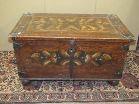 An early 19th century pine coffer, with geometric painted detail, steel banded corners and lock