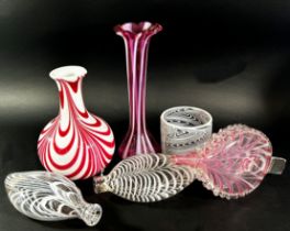 A collection of 19th century Nailsea glassware, including a pink candy stripe bellows, two flats
