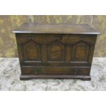 A small, good quality reproduction oak coffer bach with hinged lid over a triple fielded panelled