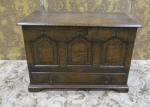 A small, good quality reproduction oak coffer bach with hinged lid over a triple fielded panelled
