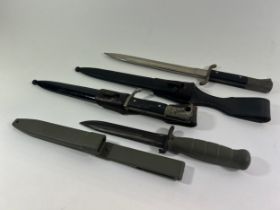 Two 19th century German Military Bayonets and a 20th century German dagger in a green plastic