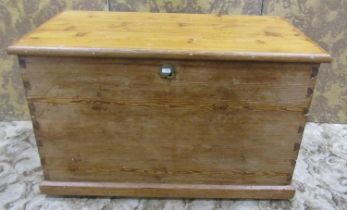 A stripped pine blanket box with hinged lid and brass drop side carrying handles, 56 cm high x 91 cm
