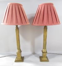 A pair of brass column table lamps both with shades 48cm tall.