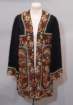 An unusual early 20th century handmade jacket composed of colourful floral silk embroidery on a