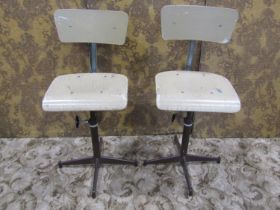 A pair of vintage swivel machinist/typist chairs with moulded plywood seats and backs