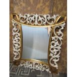 A contemporary partially gilded wall mirror with pierced detail, 100cm x 110cm