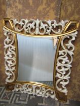 A contemporary partially gilded wall mirror with pierced detail, 100cm x 110cm