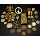 A collection of WWI regimental cap badges mainly commonwealth, together with a small number of coins