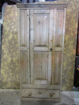 A rustic country pine hanging cupboard, with fielded panelled front over a single drawer, 200cm