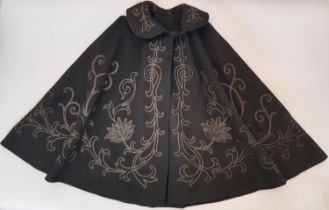 Early 20th century black woollen cape decorated in Art Nouveau style floral motifs with hook and eye