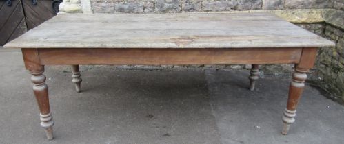 A Victorian farmhouse kitchen table raised on turned tapered supports (af), 197cm x 102 x 72cm