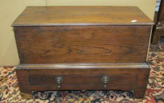 An antique oak coffer bach, with rising lid over a shallow frieze drawer on shaped supports, 35cm