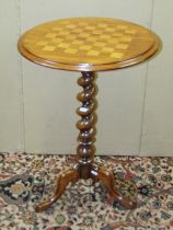 A 19th century rosewood chess table raised tapered barley twist column and a tripod base, 47cm