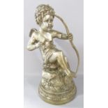 A classical statuette of Cupid letting loose an arrow, his gaze fixed on his victim, in a silver