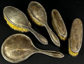 Four silver backed brushes and a single silver backed hand mirror (5)