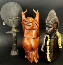 Three various carved African and other figures to include and Ashanti fertility doll, and African