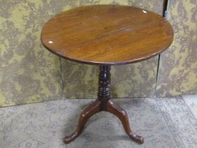 A 19th century oak snap top occasional table of circular form raised on a ring turned pillar and