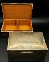 A silver cigarette box engraved with inscriptions, together with a matching similar cigarette box (