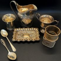 A mixed selection of silver including a cream jug, two napkin rings, a beaker, dish, a twin