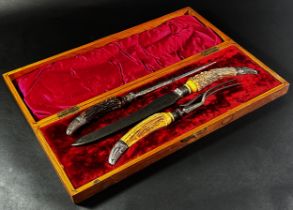 A substantial 19th century carving set with stag horn handles in an oak box together with a