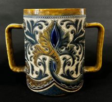 A Doulton Lambeth stoneware harvest mug with incised floral detail