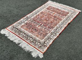 A silk Bidjar design carpet with an all over floral pattern and floral borders, 190cm x 120cm