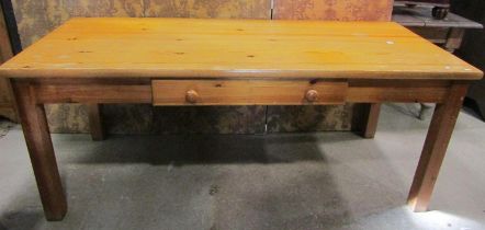 A Habitat pine kitchen table of rectangular form with frieze drawer raised on four detachable square