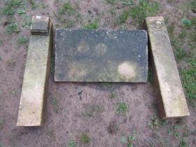 Three sections of weathered cut natural Bath stone forming a small fire surround