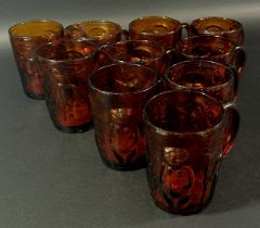 Ten Erik Hoglund amber coloured drinking glasses, decorated with naked people, some with original