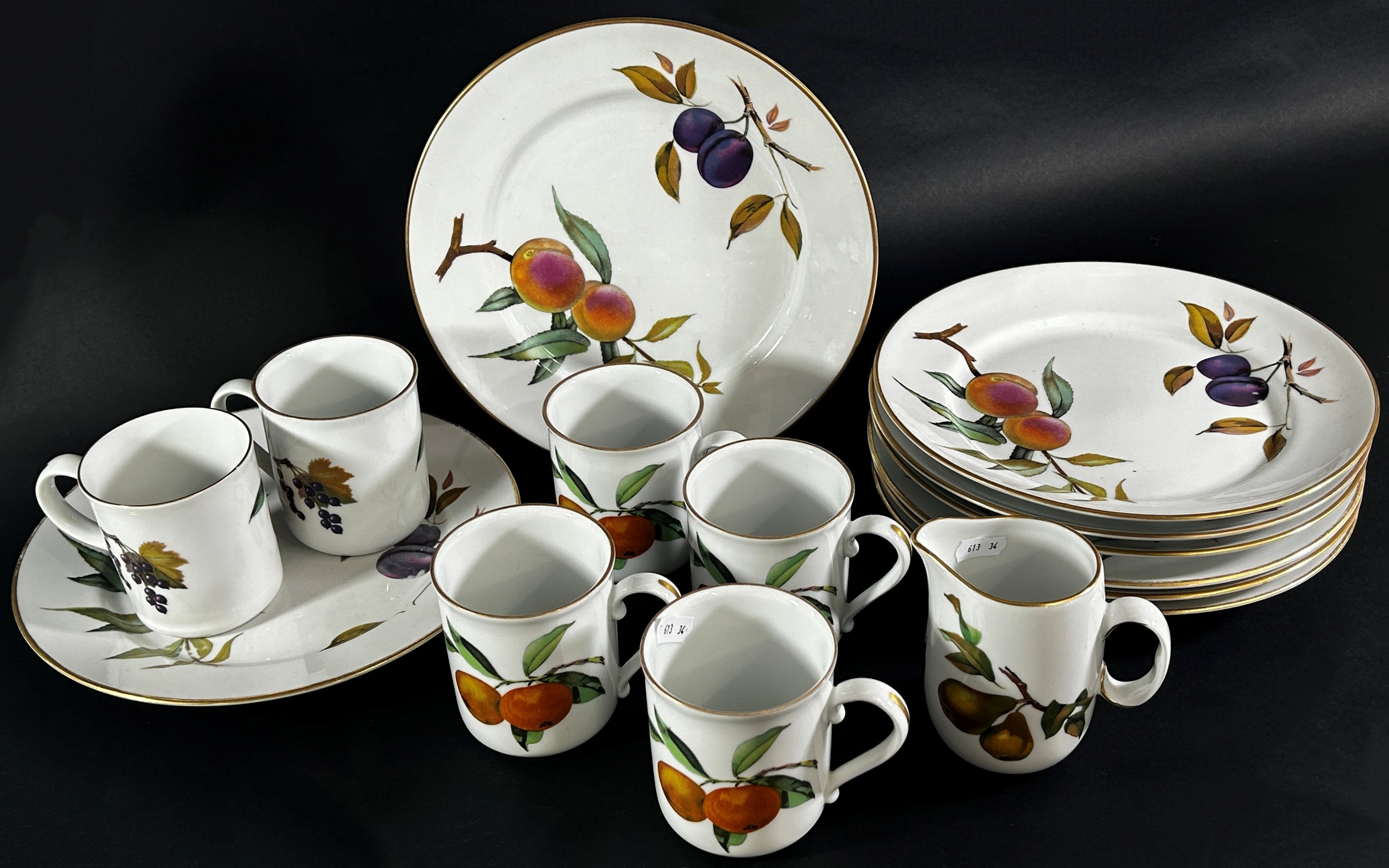 A large mixed group of Royal Worcester Evesham dinner wares to include dinner plates, mugs, milk