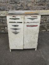 A vintage heavy gauge industrial painted steel two door cabinet with applied car badges 72 cm high x