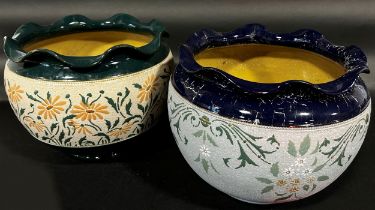 Two Langley ware ceramic jardinières, one green/peach, the other blue/green, with repeating floral