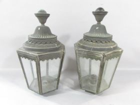 A pair of Victorian hexagonal carriage lamps, in a weathered finish, 33cm high. (One glass panel