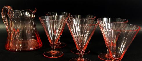 An Art Deco pink glass drinks set, with a single jug and six conical glasses.
