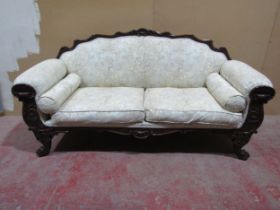A Regency drawing room sofa with showwood frame depicting shells, scrolls and other detail, raised