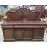 A Victorian mahogany sideboard, the shallow inverted base enclosing four arched moulded panelled