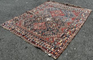 An old Persian Heriz carpet with an all over stylised flower and geometric pattern 246cm x 200cm