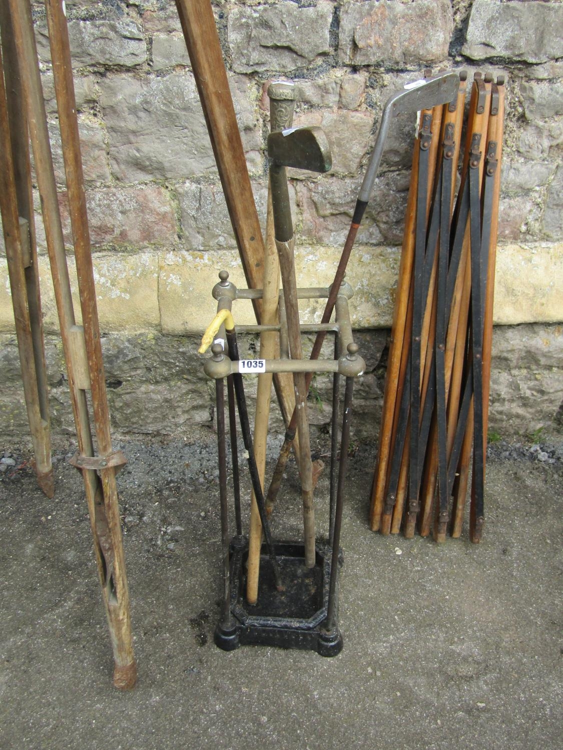 A vintage cast iron and brass four divisional umbrella/stick stand containing various canes and - Image 2 of 5