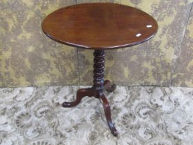 A Victorian mahogany snap top occasional table of oval form raised on a bobbin turned pillar and