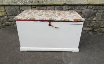 An old painted pine blanket box with later upholstered lid 48 cm high x 83 cm x 47 cm