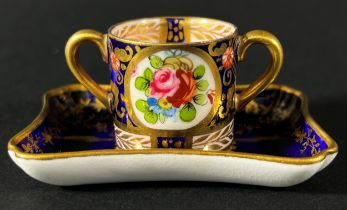 A miniature Coalport pin tray with dark blue ground and central landscape panel, 7cm long, with