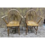 A Pair of vintage Ercol elm and beechwood stick back elbow chairs