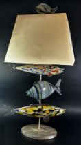 An unusual mid-century Murano glass fish lamp, with three fish swimming below the square cut shade